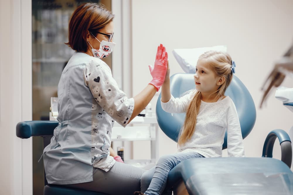 cute little girl sitting dentist s office 1 Paediatric Dentistry Dubai
